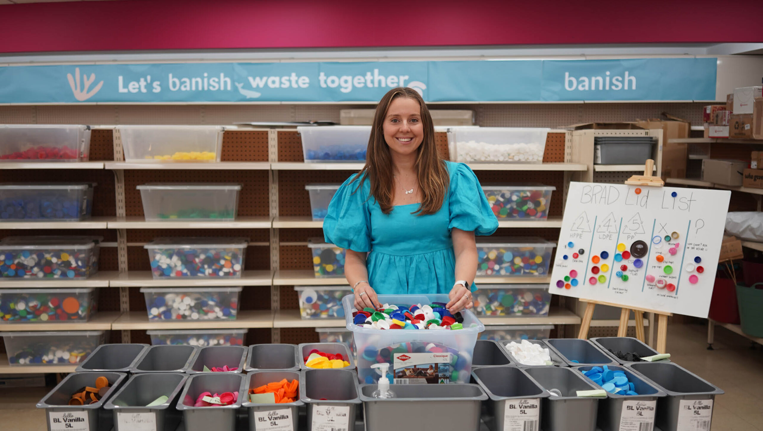 Image of Lottie Dalziel (founder of Banish) in front of the recycling drop off.